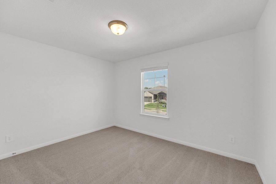 Unfurnished room with light carpet and baseboards Unfurnished room with light carpet and baseboards