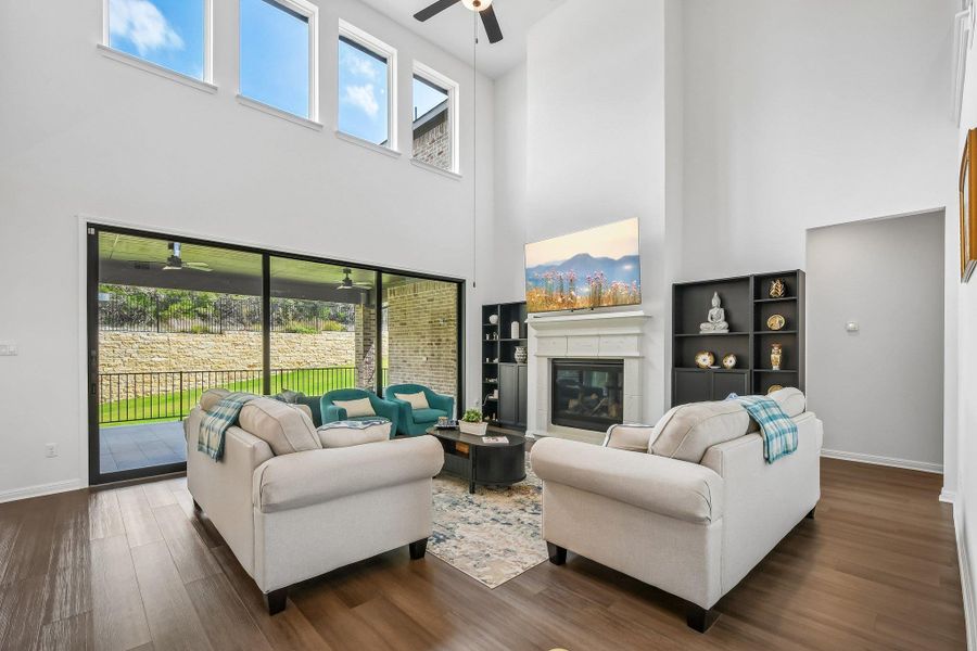 A striking living space with soaring ceilings and a cozy fireplace creates a warm atmosphere.