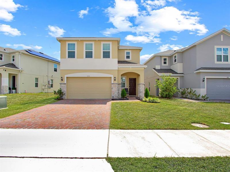 Front exterior of a new home in , Kissimmee, FL, highlighting curb appeal (Image 22).