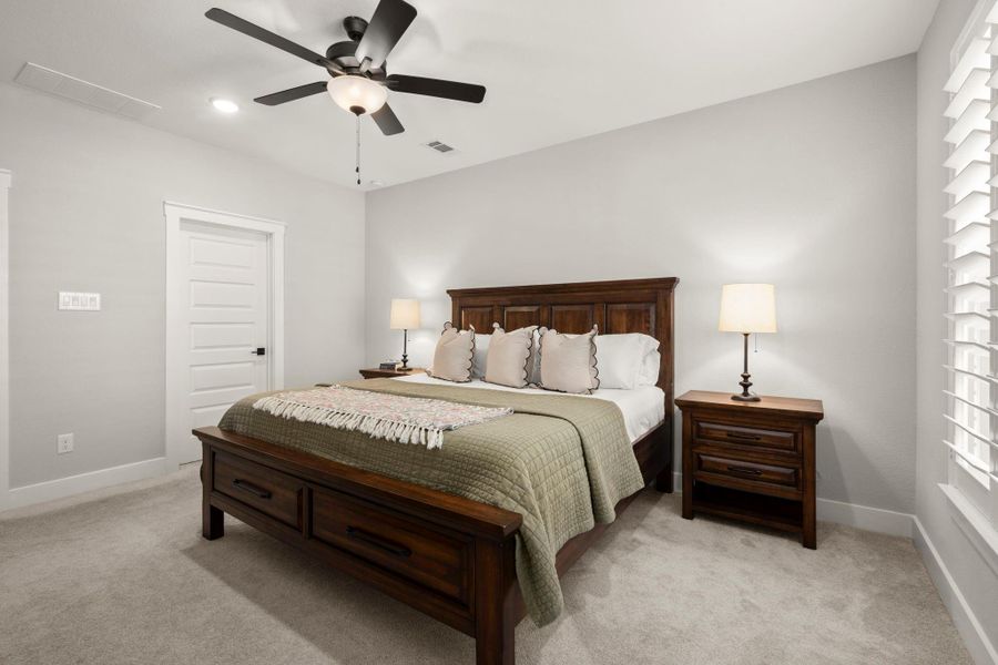 Tucked away on the main floor, the primary bedroom offers privacy and generous space. Tucked away on the main floor, the primary bedroom offers privacy and generous space.