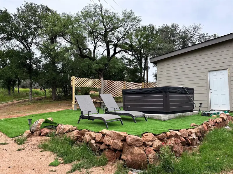 View of yard with a hot tub View of yard with a hot tub