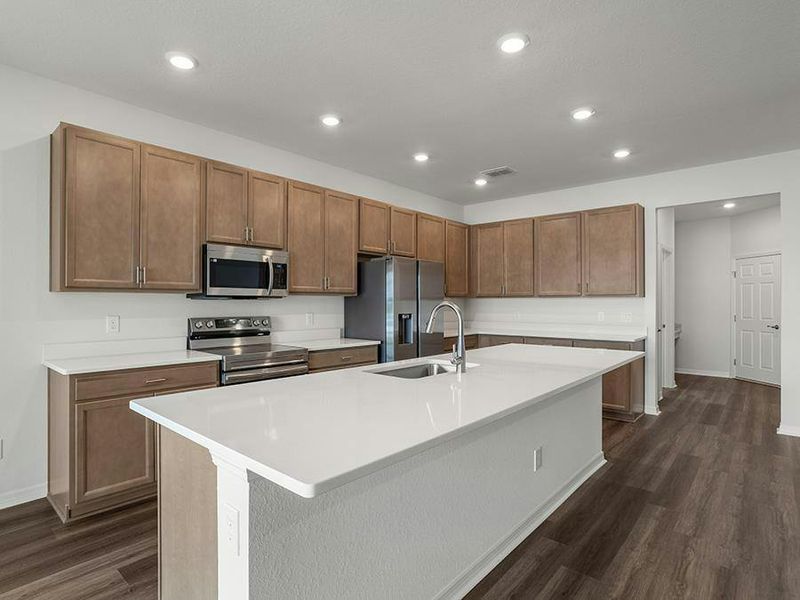 Your spacious, open kitchen includes quartz, 36-inch cabinets, Samsung SS appliances, and a walk-in pantry.