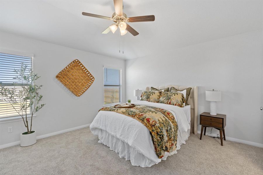 Bedroom featuring light carpet and a ceiling fan
