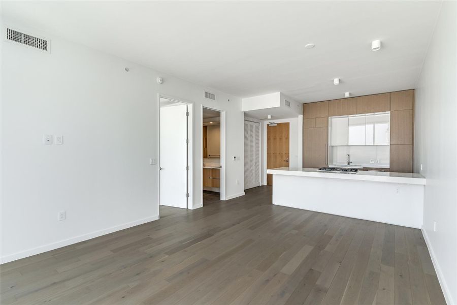 The open-concept layout creates an airy flow between the living space and the modern kitchen island. The open-concept layout creates an airy flow between the living space and the modern kitchen island.