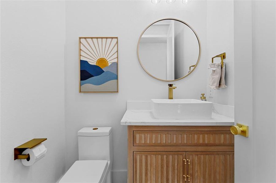 Half Bathroom featuring vanity and toilet located on the 1st floor. Half Bathroom featuring vanity and toilet located on the 1st floor.