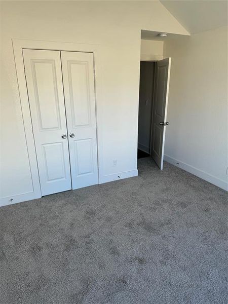 Another view of 2nd bedroom featuring a closet, and vaulted ceiling