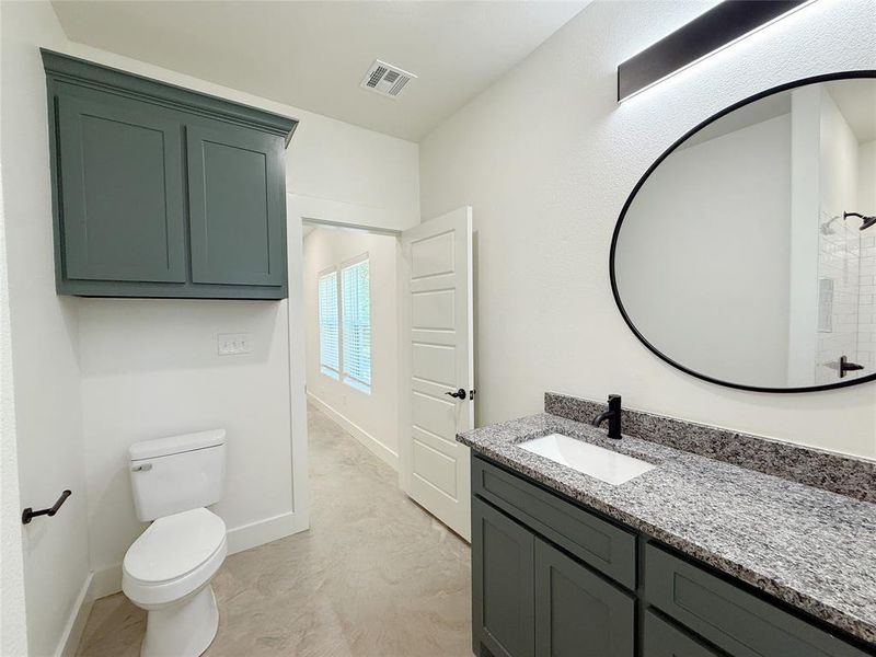 Bathroom featuring vanity, visible vents, toilet, walk in shower, and baseboards Bathroom featuring vanity, visible vents, toilet, walk in shower, and baseboards