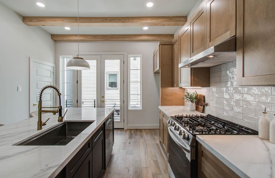 Kitchen view looking towards the balcony large enough for a bistro table and grill.