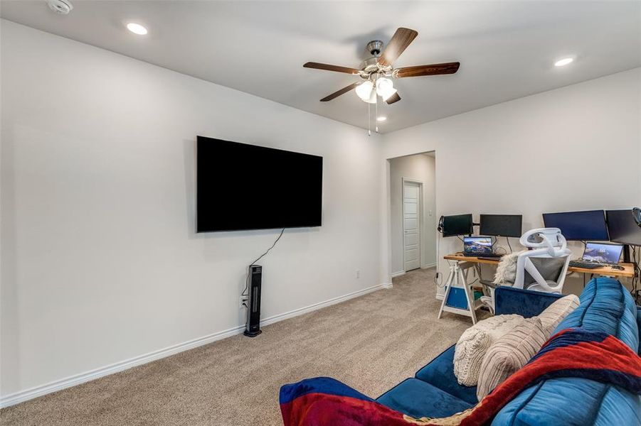Living room with carpet flooring, recessed lighting, and a ceiling fan Living room with carpet flooring, recessed lighting, and a ceiling fan