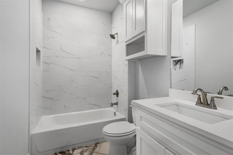 Secondary Bathroom with Tiled Wall and custom cabinets