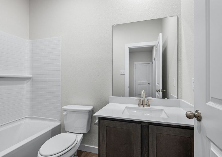 The secondary bathroom has a sprawling vanity space.