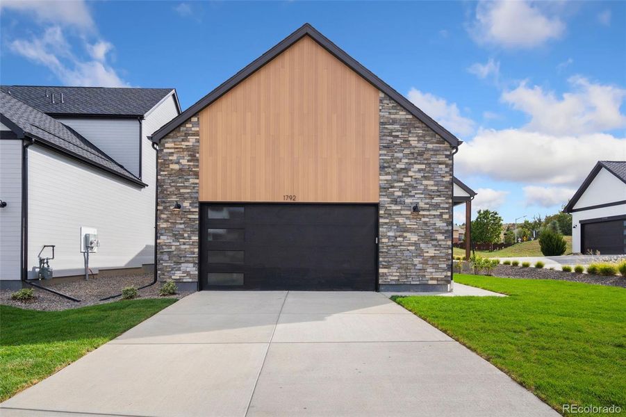 Front exterior of a new home in Pelican Shores at Water Valley, Windsor, CO, highlighting curb appeal (Image 2).