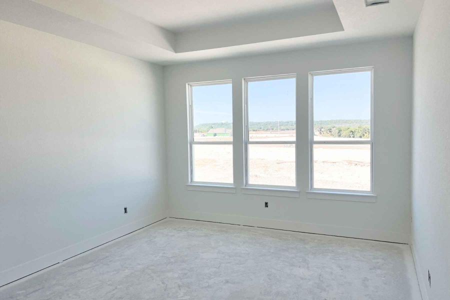 Spare room with a tray ceiling and baseboards Spare room with a tray ceiling and baseboards