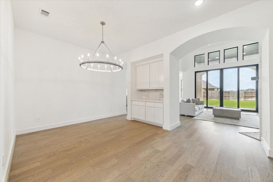 View of how open the formal Dining room is to the Kitchen and through the arches is the Family Room. View of how open the formal Dining room is to the Kitchen and through the arches is the Family Room.
