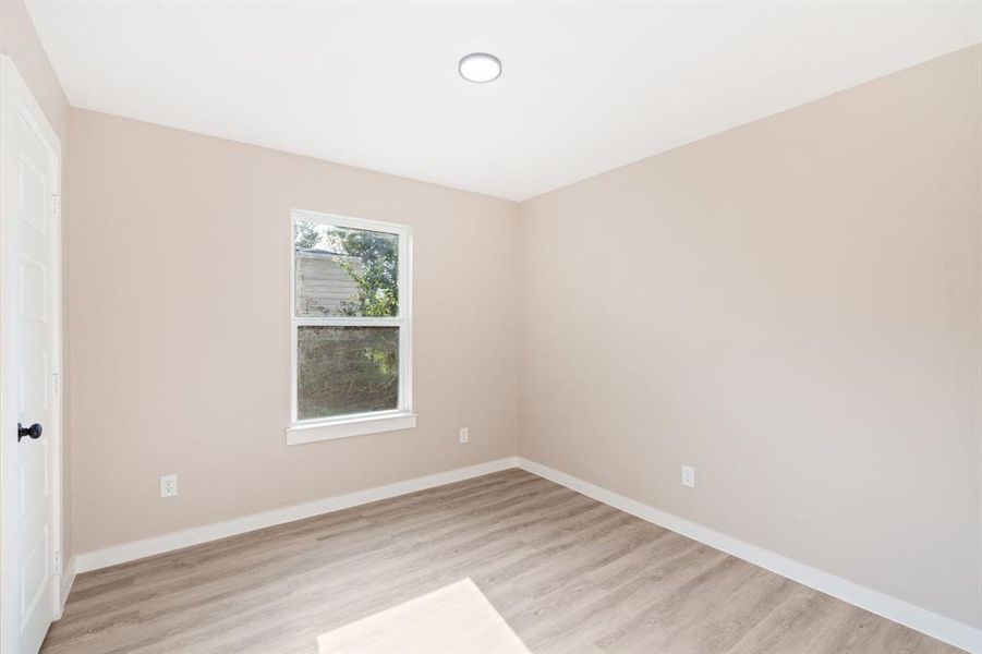 Unfurnished bedroom featuring light wood finished floors and a closet