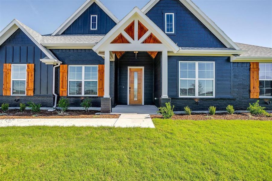 Craftsman-style home featuring a front lawn