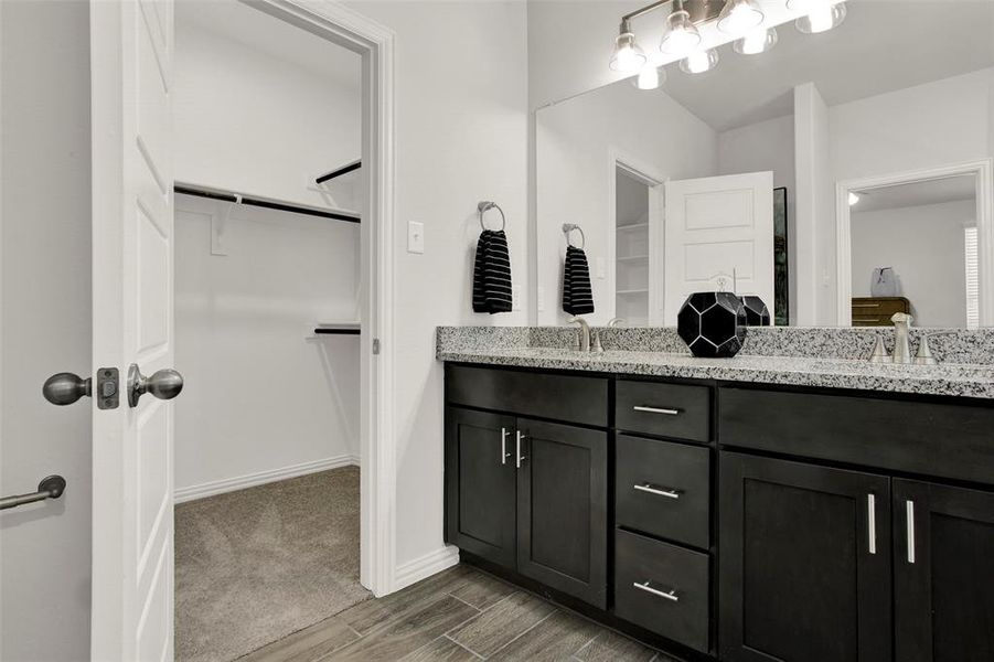 Bathroom featuring hardwood / wood-style flooring and dual bowl vanity