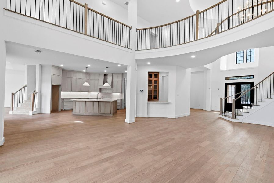 bright, spacious kitchen that immediately feels like the heart of the home.kitchen with abundant cabinets, a large island, and convenient second staircase leading directly to the upstairs gameroom.
