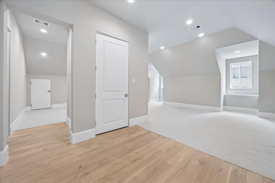 As you enter the third floor, you are greeted by a generously-sized gameroom with access to a full bath, and an additional bedroom space.