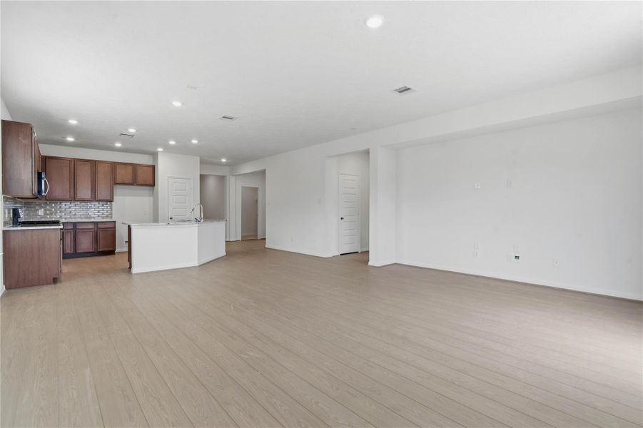 Additional view of the open concept living space with sightlines to the Den and hallway to entryway. Additional view of the open concept living space with sightlines to the Den and hallway to entryway.