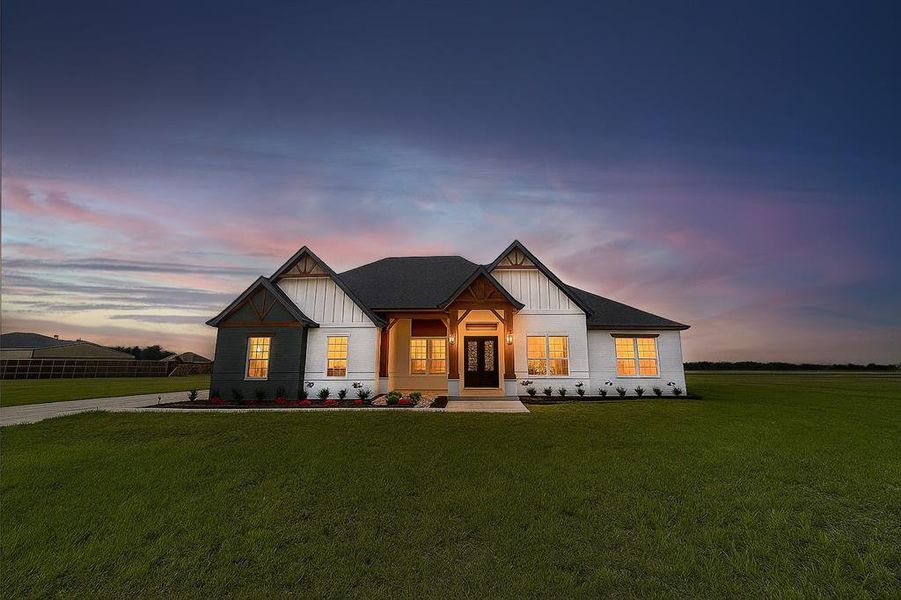 Modern farmhouse style home featuring a lawn, board and batten siding, and a porch Modern farmhouse style home featuring a lawn, board and batten siding, and a porch
