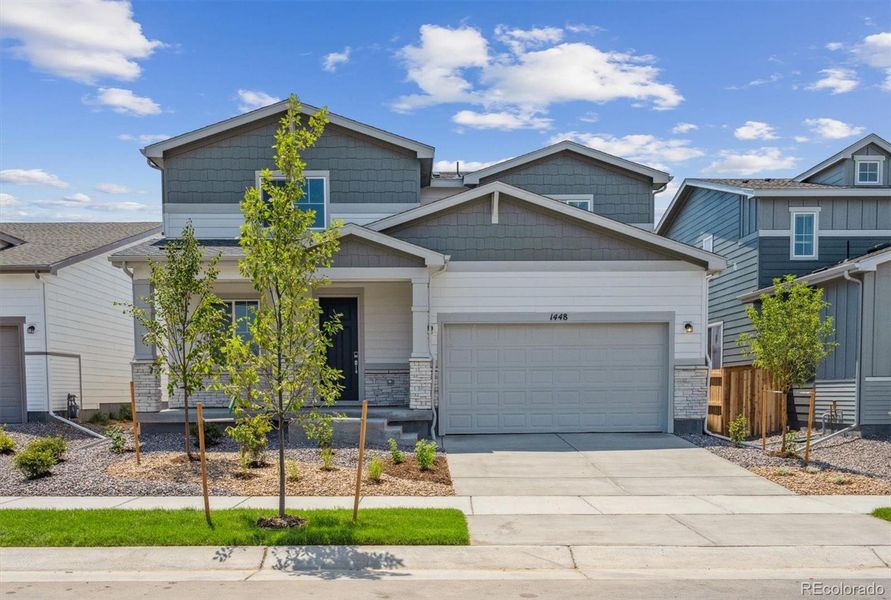 Front exterior of a new home in Farmlore, Brighton, CO, highlighting curb appeal (Image 12).