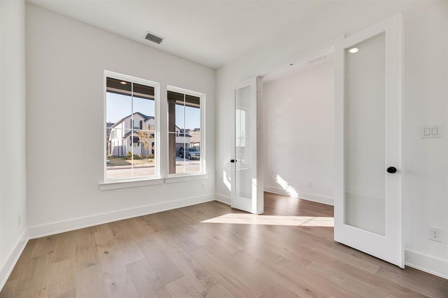 Unfurnished room featuring baseboards and light wood-style flooring