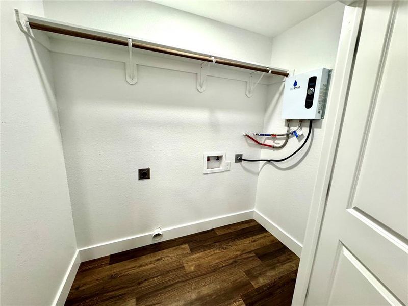 Washroom with hookup for an electric dryer, dark wood-style flooring, hookup for a washing machine, and water heater