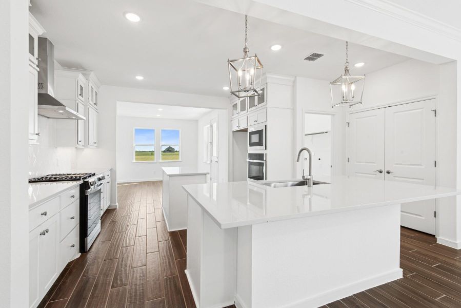 Stunning kitchen with white stacked cabinets and quartz counters