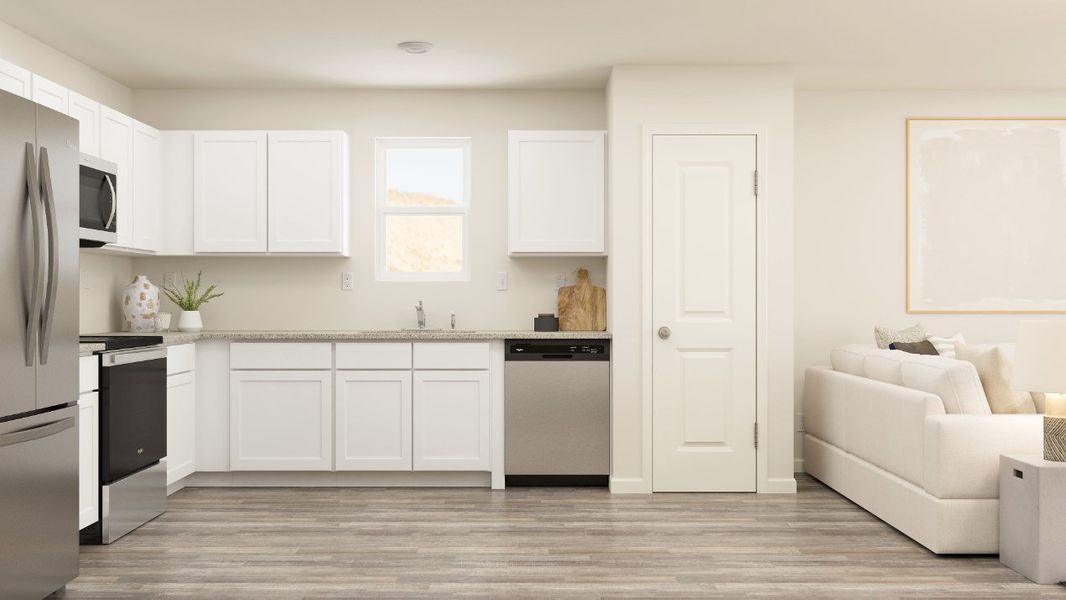 A kitchen with white cabinets.