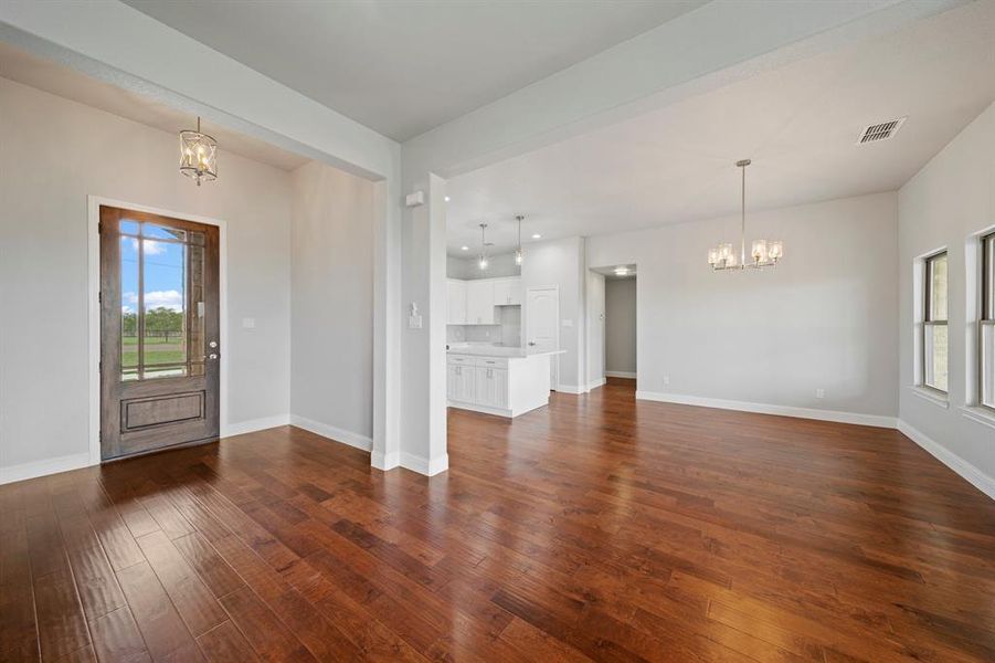 Entryway with a chandelier and hardwood / wood-style floors