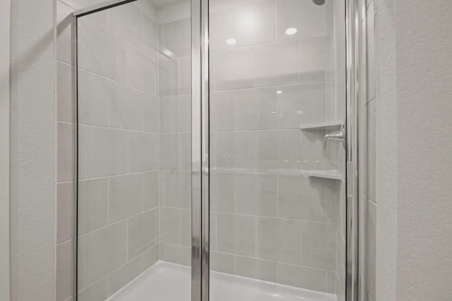 A shower with a glass door. A shower with a glass door.