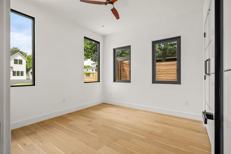 Blonde hardwood flooring complements the naturally illuminated walls of this adaptable flex space. Blonde hardwood flooring complements the naturally illuminated walls of this adaptable flex space.