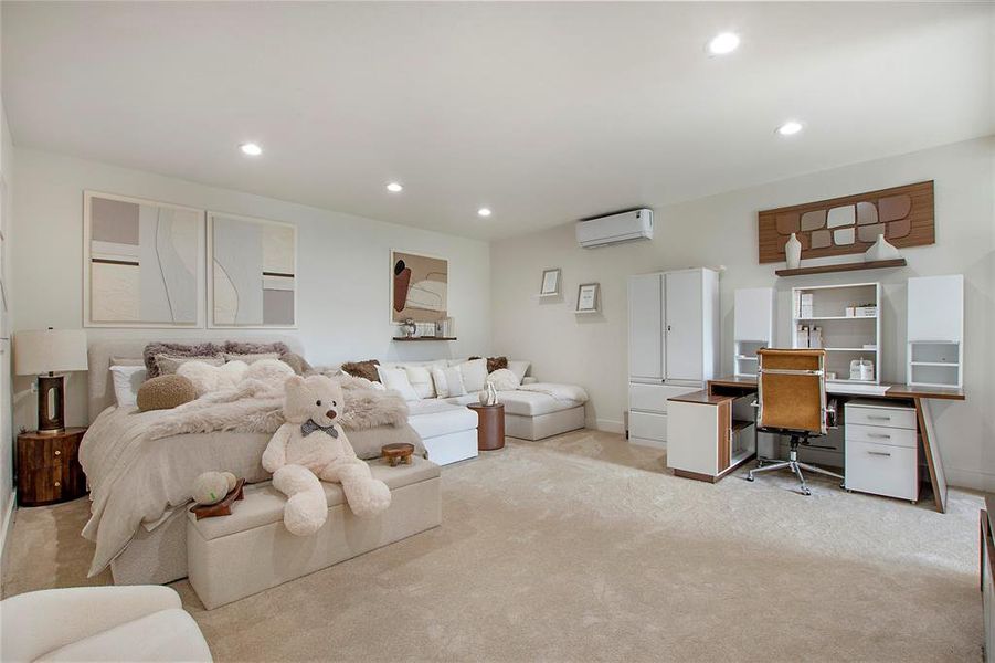 Bedroom featuring recessed lighting, an office area, carpet, and an AC wall unit Bedroom featuring recessed lighting, an office area, carpet, and an AC wall unit