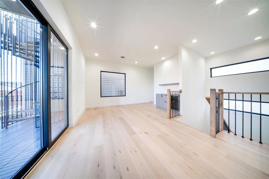 Unfurnished living room with light hardwood / wood-style floors