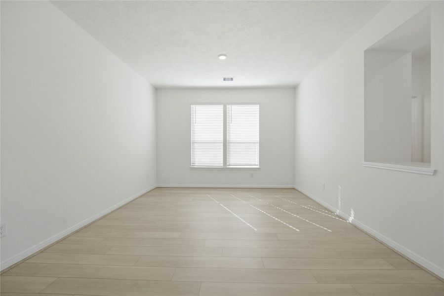 The Flex Room is versatile space that can be used as a formal dining or living room. It features Layton Lake vinyl plank flooring in Silver Dollar, high ceilings, large windows with privacy blinds and neutral paint.