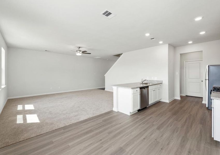 The kitchen overlooks the spacious living area.