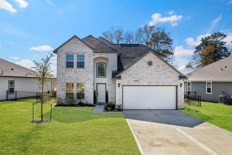 Front exterior of a new home in Lakes at Crockett Martin, Conroe, TX, highlighting curb appeal (Image 25). Front exterior of a new home in Lakes at Crockett Martin, Conroe, TX, highlighting curb appeal (Image 25).