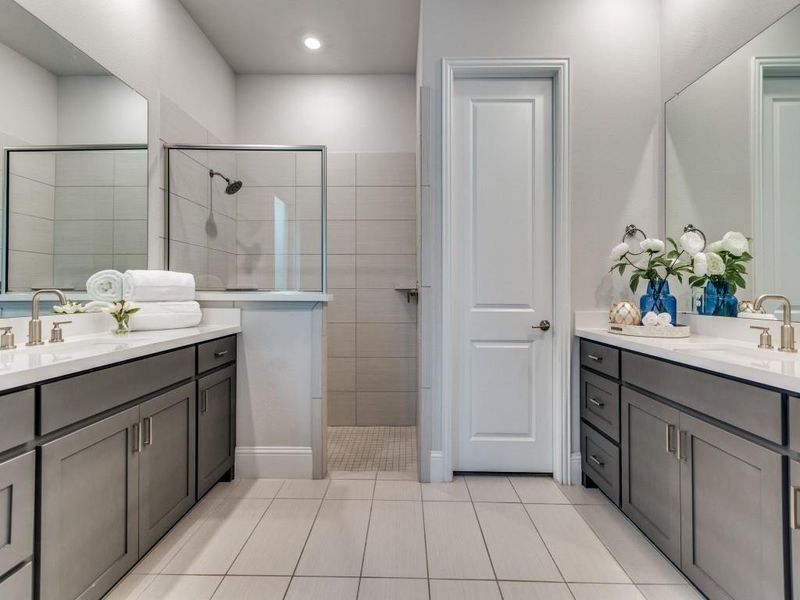 Bathroom with two vanities, tile patterned flooring, walk in shower, and recessed lighting