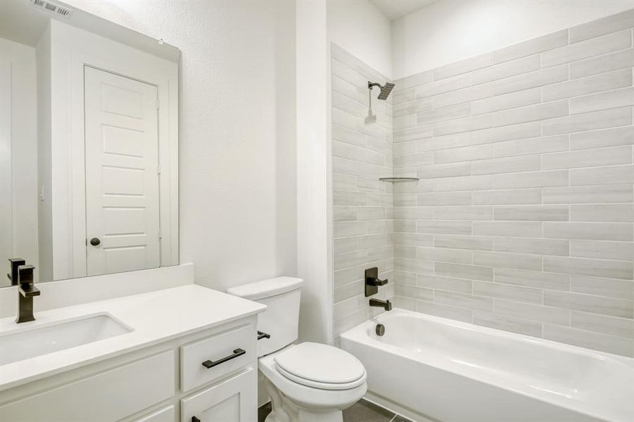 Bathroom featuring vanity and shower / washtub combination