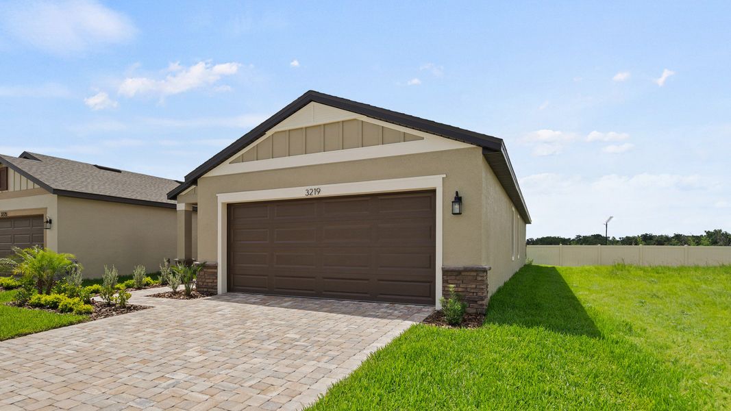 The Flagler at Grasslands West in Lakeland, FL—next to Grasslands Golf Course—features a paver drive and 2-car garage.