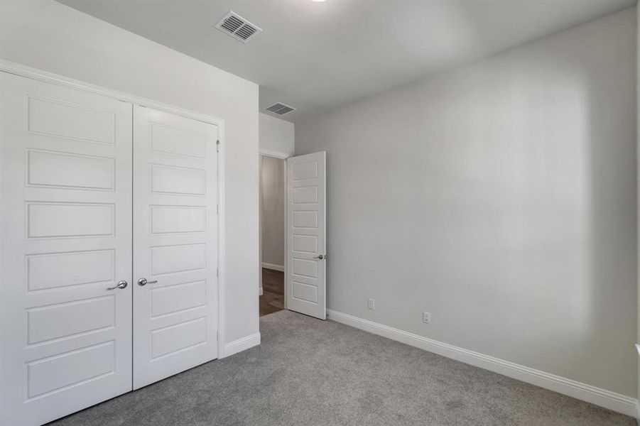 Unfurnished bedroom featuring a closet and carpet