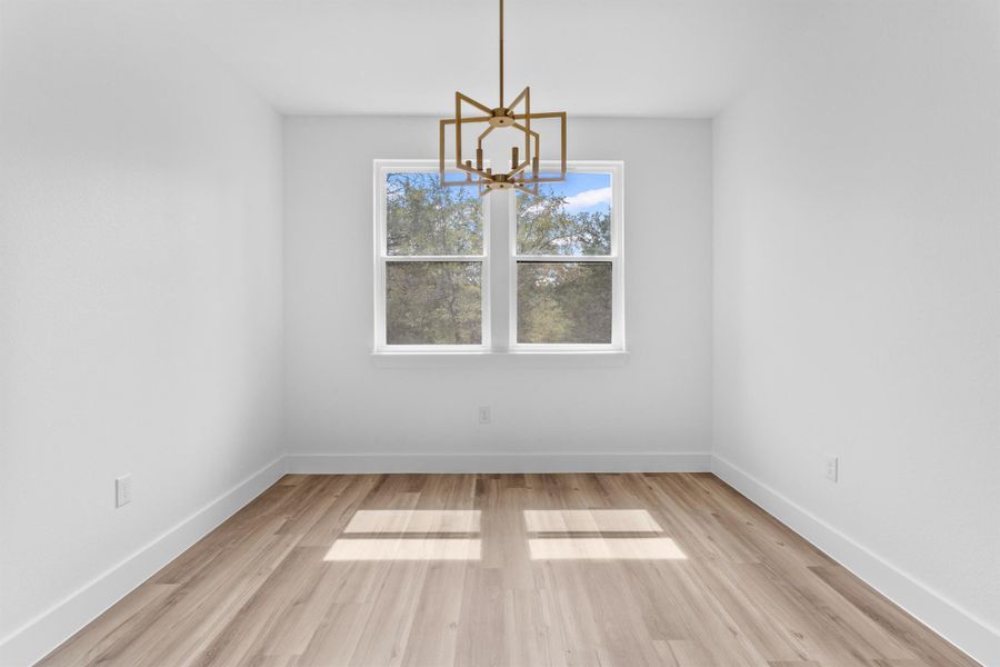Unfurnished dining area with light wood-style floors and a chandelier