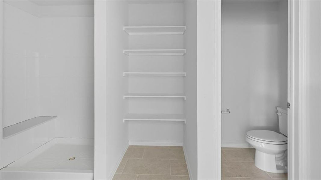 Full bathroom featuring a shower stall and light tile patterned floors Full bathroom featuring a shower stall and light tile patterned floors