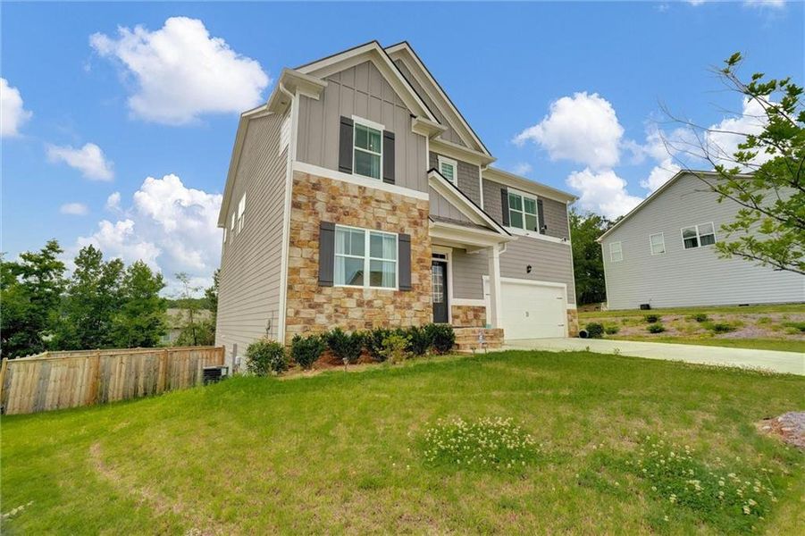 Front exterior of a new home in Thompson Ridge, Dallas, GA, highlighting curb appeal (Image 26). Front exterior of a new home in Thompson Ridge, Dallas, GA, highlighting curb appeal (Image 26).