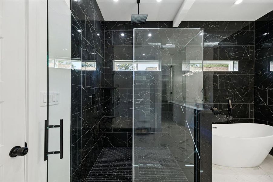 Bathroom with healthy amount of natural light, a freestanding bath, marble finish flooring, a marble finish shower, and beamed ceiling