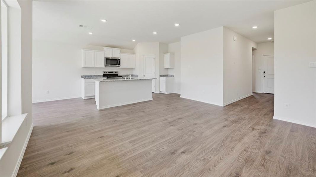 Unfurnished living room featuring light wood-style flooring and recessed lighting