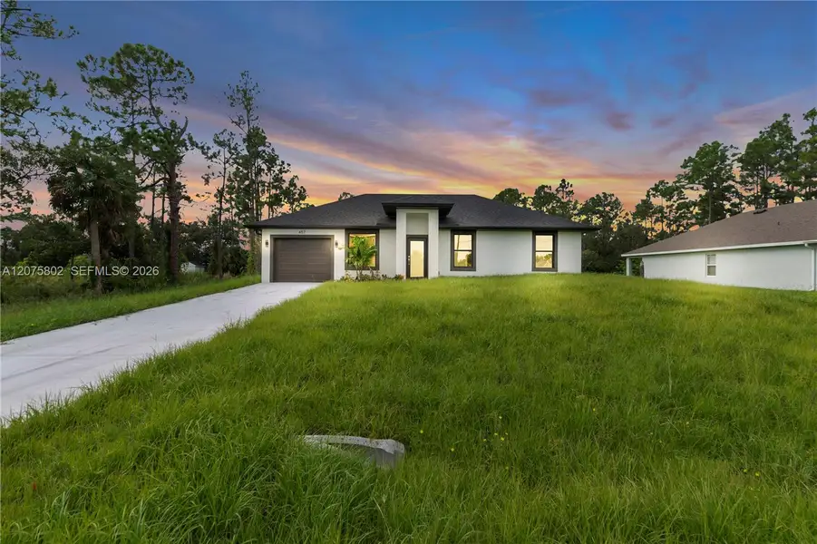 Front exterior of a new home in , Lehigh Acres, FL, highlighting curb appeal (Image 19).