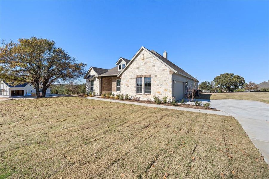 Front exterior of a new home in Oak Grove Addition, Springtown, TX, highlighting curb appeal (Image 22).