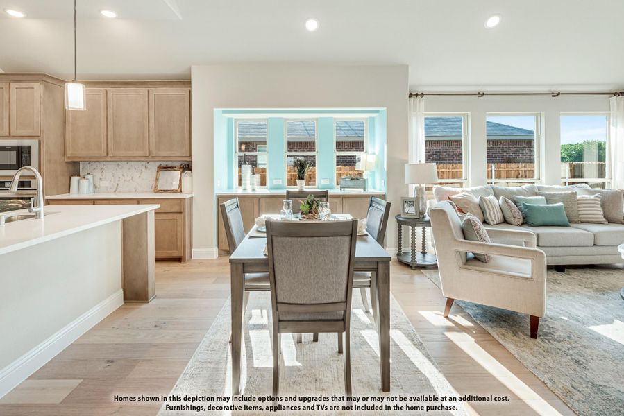Open-concept living area with dining table, kitchen with light wood cabinets, and living room with large windows and hardwood floors. Open-concept living area with dining table, kitchen with light wood cabinets, and living room with large windows and hardwood floors.